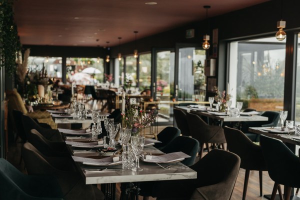 Interior moody setting dining room wine glasses evening shot lights