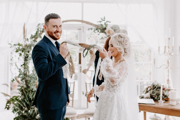 bride and groom vows arch backdrop at ceremony