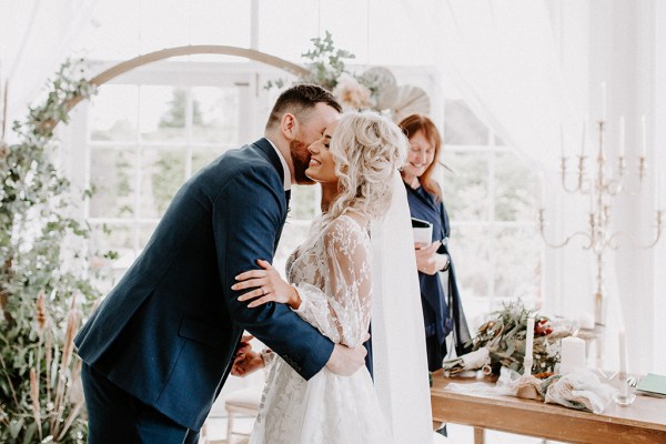 groom kissing bride