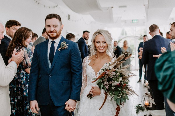 bride and groom walking down aisle