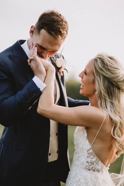 bride and groom kissing in barley field