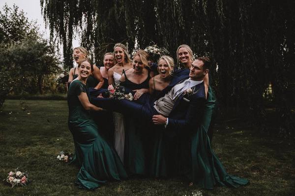 bridesmaids lifting groom