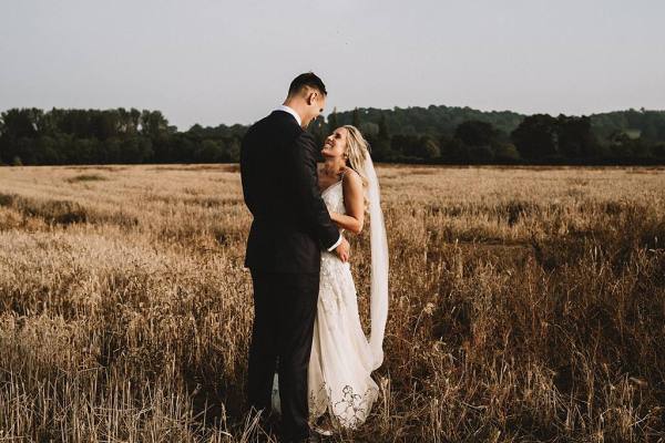 bride and groom in field