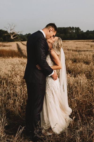 bride and groom in field