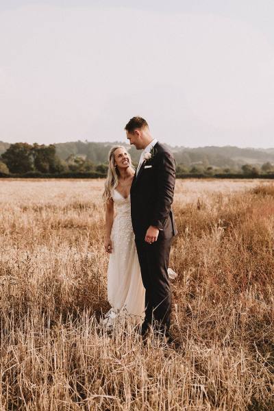 bride and groom in field