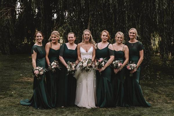 bride with bridesmaids in green dresses