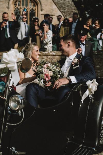 bride and groom in wedding car