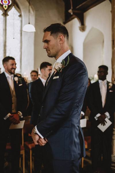 groom waiting for bride in churchh