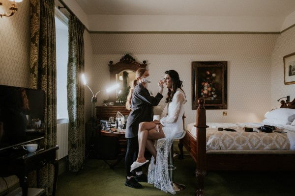 Makeup artist/MUA is putting makeup on bride