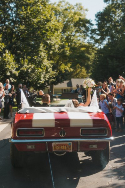 bride and groom wedding car red convertible