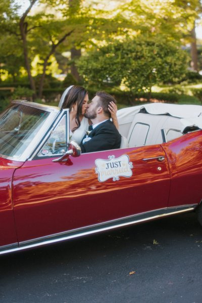 bride and groom wedding car red convertible