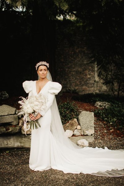 bride long sleeve dress puffy sleeves and headpiece headband white bridal bouquet white roses and white fern