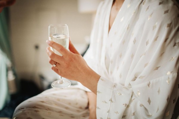 bride in robe with prosecco