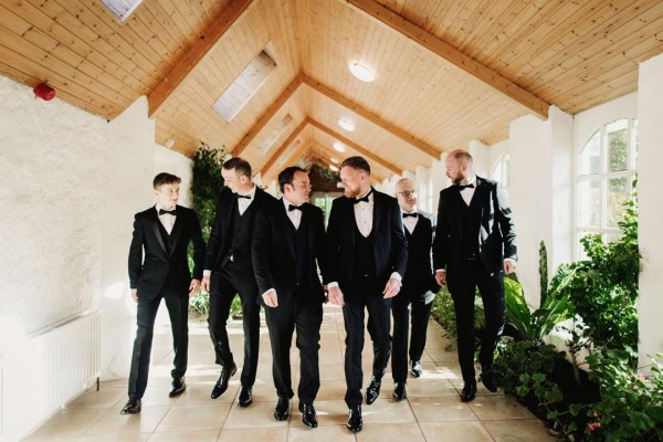 groomsmen in black tuxedos