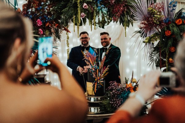 groom and groom cutting the cake with moongate