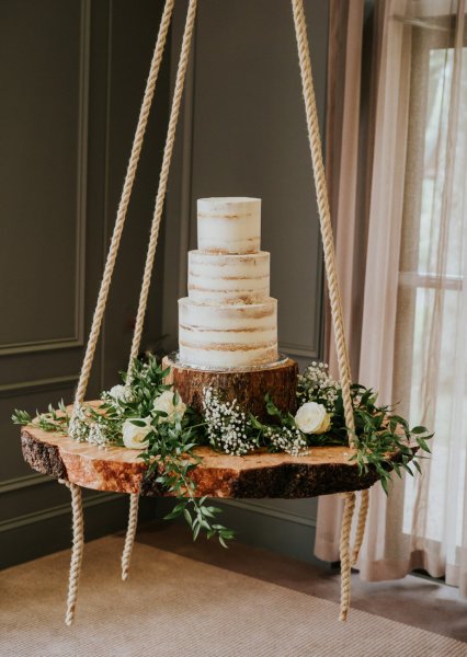 naked cake on wooden slice swing