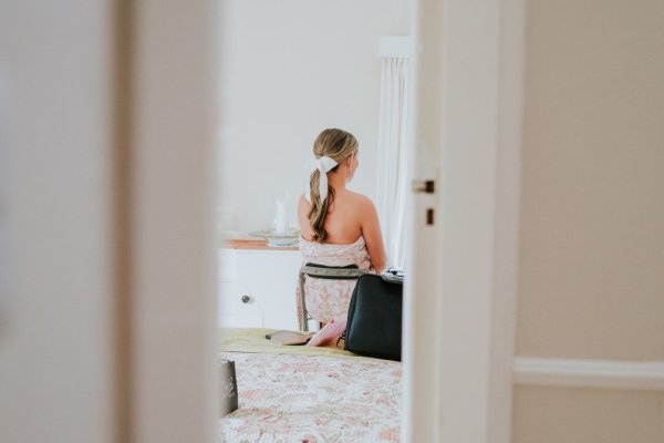 bride getting ready bow in hair ponytail