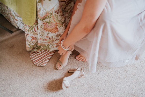 bride getting shoes on