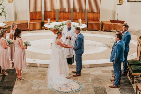 bride and groom at top of altar