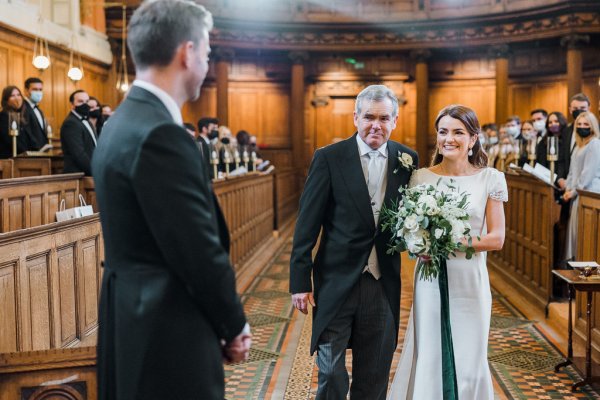 Father of the bride walking bride down aisle