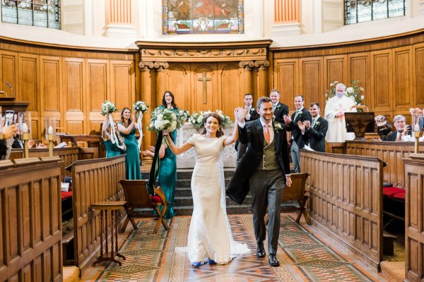 Bride groom just wed walking down aisle