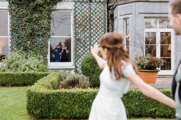 Trinity College church bride groom flowers veil college university Christmas venue waving