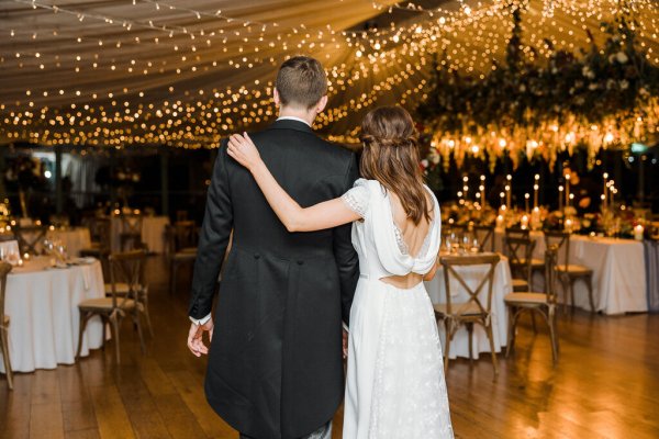 Bride groom interior dining room hugging embracing