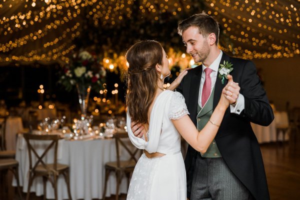 Bride groom first dance lights in background