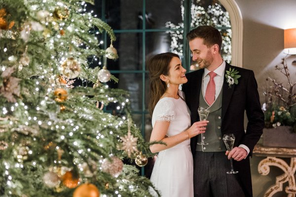 Bride groom Christmas tree lights winter wedding