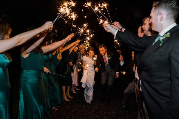 Cheers sparklers couple bride groom just married celebration guests