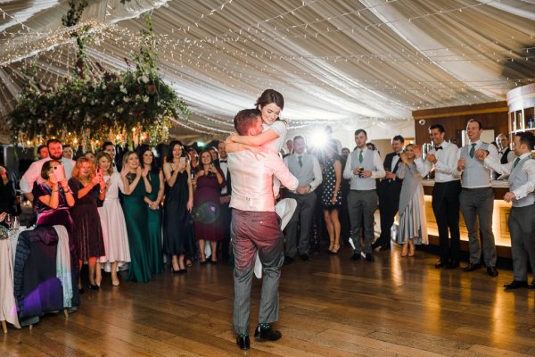 Bride and groom dance dancefloor guests