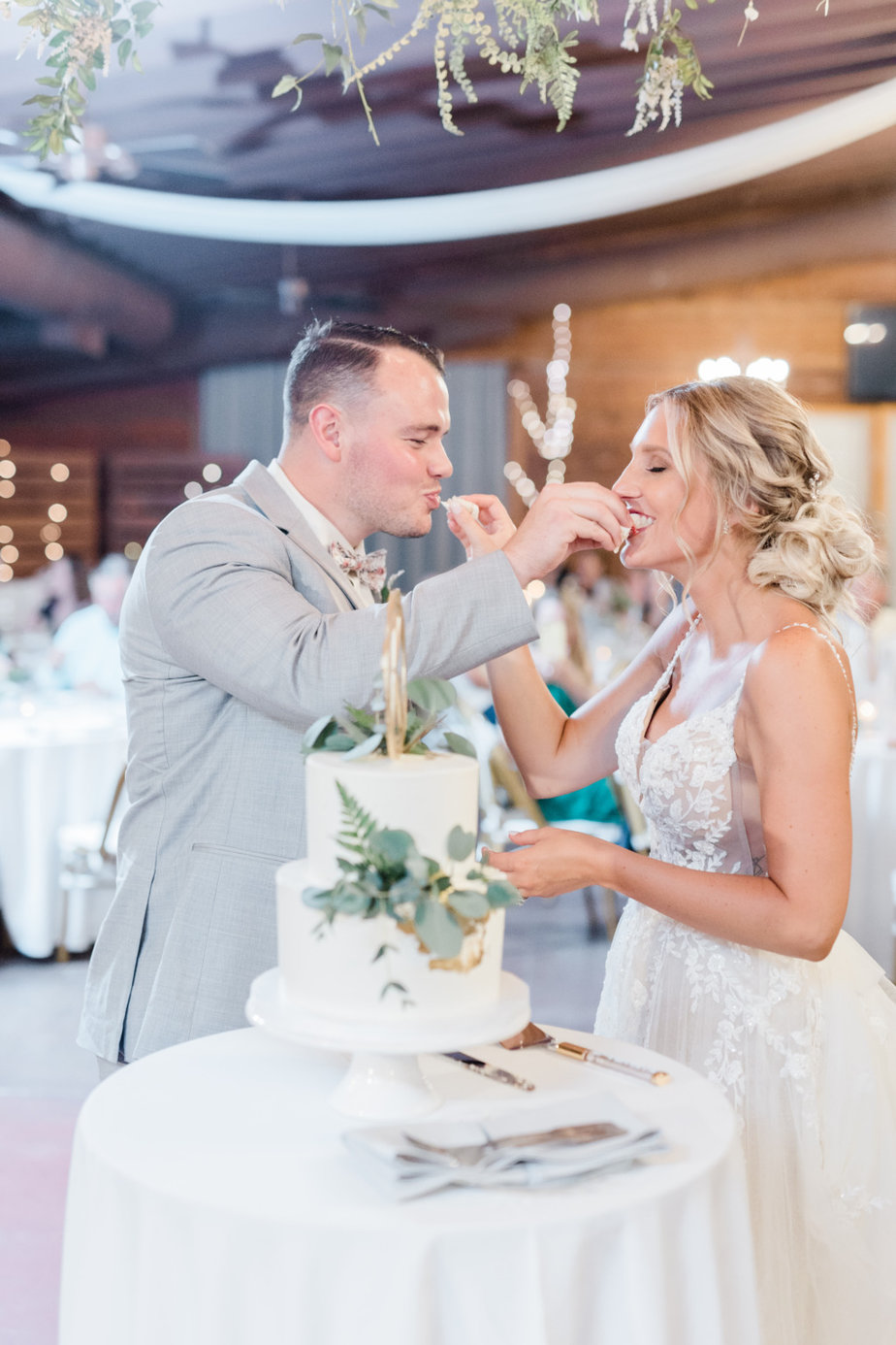 Bride and groom feeding each other cake