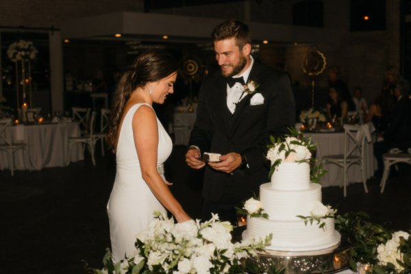 bride and groom cutting cake