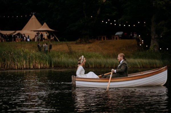 bride and groom paddle boat