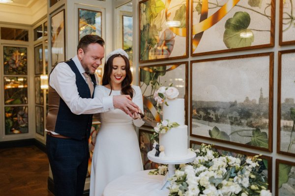 bride and groom cutting the cake