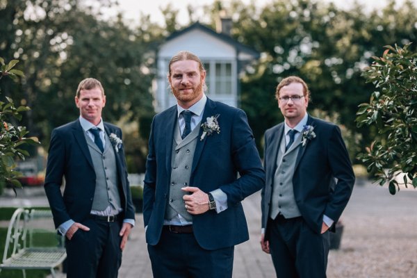 groomsmen in navy and grey suits