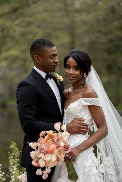 Bride and groom bouquet pink roses flowers elegant mountain scenic lake embrace