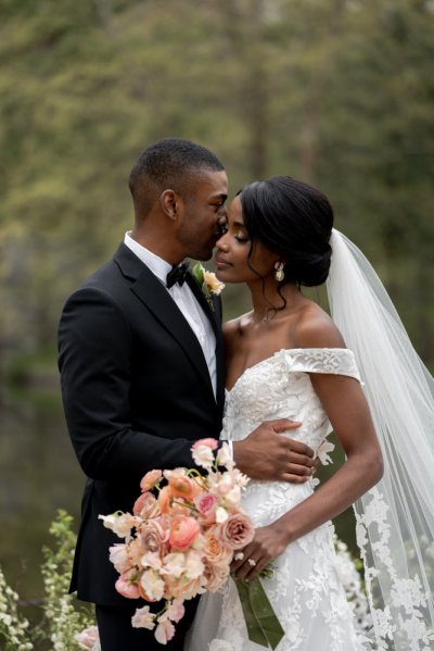 Bride and groom bouquet pink roses flowers elegant mountain scenic lake embrace