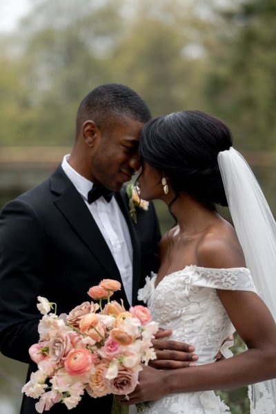 Bride and groom bouquet pink roses flowers elegant mountain scenic lake embrace