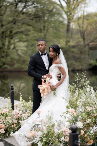 Bride and groom bouquet pink roses flowers elegant mountain scenic lake embrace