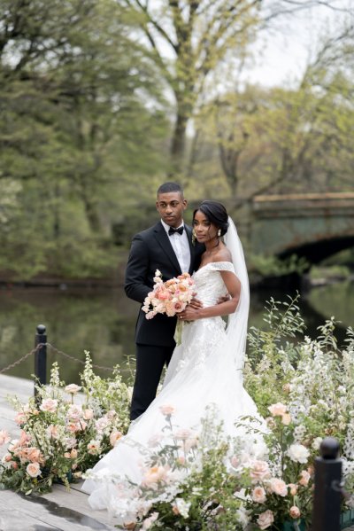 Bride and groom bouquet pink roses flowers elegant mountain scenic lake embrace