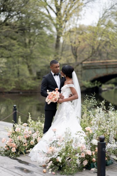 Bride and groom bouquet pink roses flowers elegant mountain scenic lake embrace