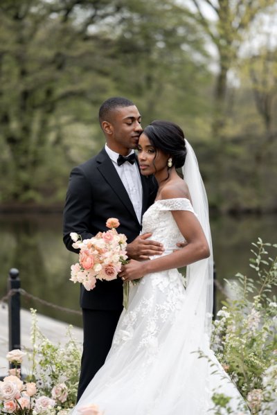 Bride and groom bouquet pink roses flowers elegant mountain scenic lake embrace