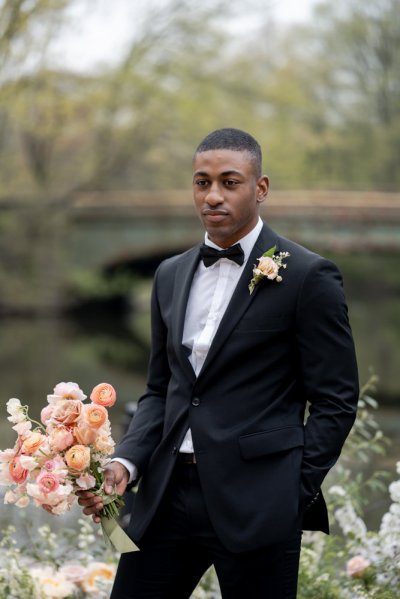 groom on his own scenic lake mountain landscape pink flowers