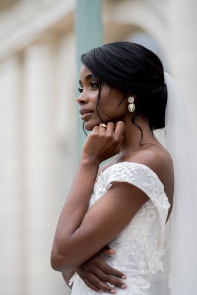 bride on her own exterior hotel pose earring detail