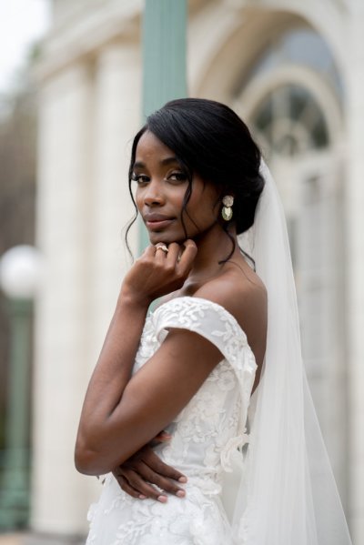 bride on her own exterior hotel pose earring detail