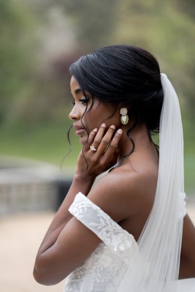 bride on her own exterior hotel pose earring detail