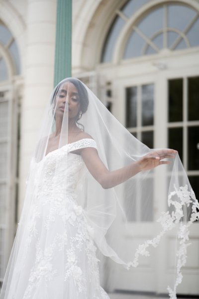 bride on her own exterior hotel pose earring detail veil