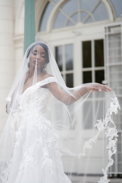 bride on her own exterior hotel pose earring detail veil