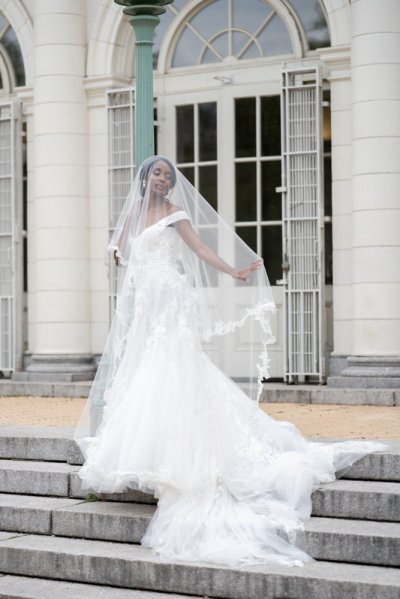 bride on her own exterior hotel pose earring detail veil